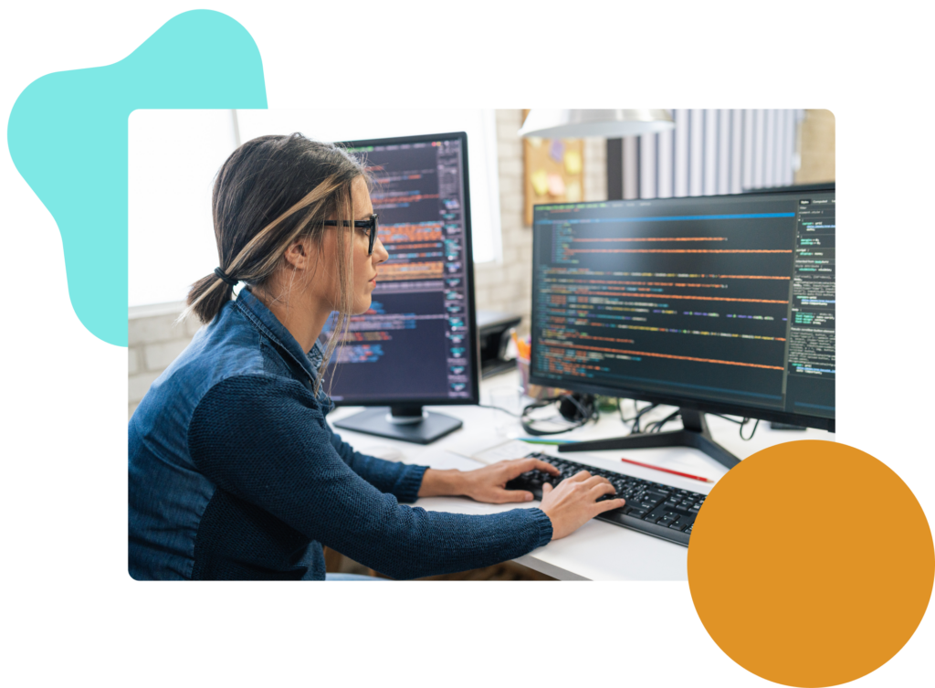 Woman at a computer with code on the screen